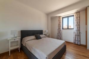 a bedroom with a large bed and a window at MM San Giovanni Apartment in Rome