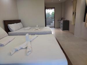 two beds in a hotel room with two beds sidx sidx sidx at Virgin River Resort Villas in Bolinao