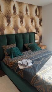 a green bed with a green headboard and pillows at Vila Green Silence in Pazin +84 photos