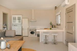 a kitchen and living room with a couch and a table at Zen Villas in Fiskardo