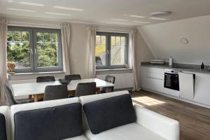 a living room with a white couch and a table at Ferienwohnung am Meer! in Alt Reddevitz