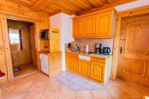 a kitchen with wooden cabinets and a counter top at Bergidyll 10 by Alpenidyll Apartments in Ramsau am Dachstein