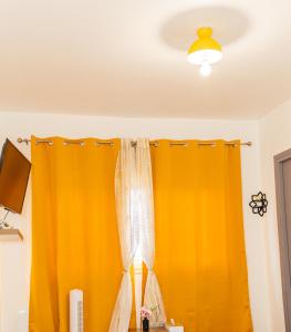 an orange curtain is hanging in a room at Sky Haven, 5Mins Orly Airport Apt 23 in Athis-Mons