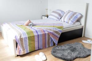 a bedroom with a bed with a colorful bedspread at Sky Haven, 5Mins Orly Airport Apt 23 in Athis-Mons