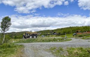 a house on the side of a dirt road at Stunning Home In Beitostølen With Sauna in Beitostøl