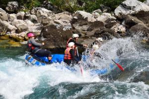 a group of people on a raft in a river at Grand Tara Rafting Resort in Foča