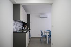 a kitchen with a sink and a table at A casa duci in Castelbuono