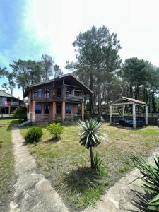 a house with a palm tree in front of it at Villa in Ureki