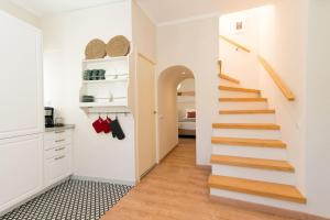 a hallway with a staircase in a house at Casa Telhados Centro Histórico Terraço Privado in Tavira