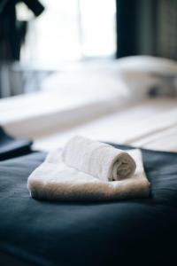 a white towel sitting on top of a bed at Live Lofoten Hotel in Stamsund