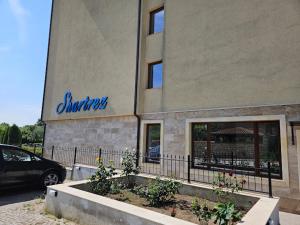 a car parked in front of a building at Azur Properties 76 in Shkorpilovtsi