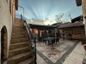 a staircase leading to a patio with a table and chairs at aynur hanım konağı butik otel in Şahinbey +21 photos