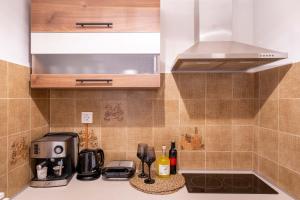 a kitchen with a counter top with a coffeemaker at La Calma in Argostoli