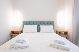 a bedroom with a bed with towels on it at La Calma in Argostoli