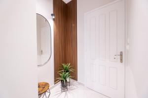 a bathroom with a door and a potted plant at La Calma in Argostoli +60 photos