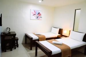 Postel nebo postele na pokoji v ubytování Arzo Hotel Makati