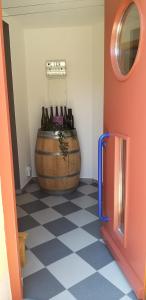 a room with a large barrel and a room with a floor with a room at Ferienwohnung Am Backhausgarten in Flonheim