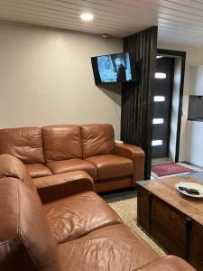 a living room with a couch and a flat screen tv at Erillistalo keskustassa in Seinäjoki
