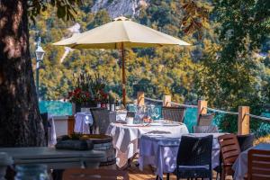 a table with an umbrella on a deck with chairs at Aquabella in Aiguebelette-le-Lac