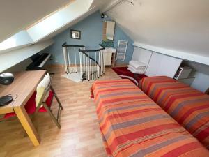 a living room with two beds and a staircase at Maison de plage in Châtelaillon-Plage