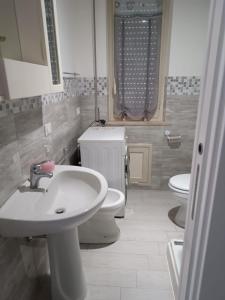 a bathroom with a sink and a toilet at The Dreams House Mondello in Mondello +11 photos