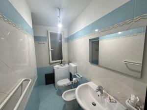 a bathroom with a sink and a toilet and a mirror at La Dimora degli ulivi in Tusa +24 photos