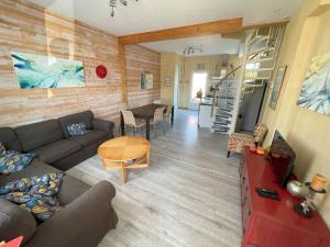 a living room with a couch and a table at Maison de plage in Châtelaillon-Plage