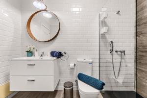 a white bathroom with a toilet and a shower at Apartamento Playa Dorada Bajos in Playa Blanca +9 photos