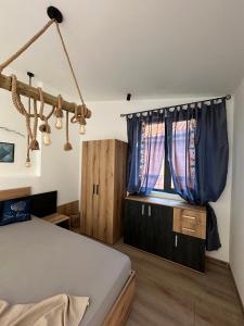 a bedroom with a bed and a window at Alta Vista Apollonia in Sozopol