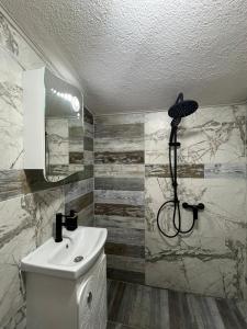 a bathroom with a sink and a shower at Alta Vista Apollonia in Sozopol +8 photos