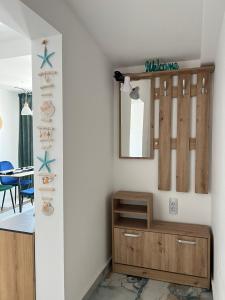 a room with a mirror and a wooden cabinet at Alta Vista Apollonia in Sozopol