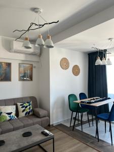 a living room with a couch and a table at Alta Vista Apollonia in Sozopol