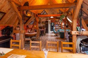 a dining room with wooden ceilings and wooden tables and chairs at Agroturystyka Hanka i Jurek in Boruja