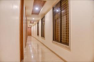 a corridor of a building with a window at FabHotel Prime OM Palace in Bhopal +31 photos