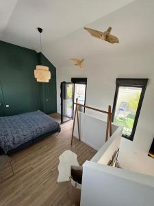 a bedroom with a bed and a staircase in it at LOFT & SPA, aux Portes de Disneyland et de Paris in Saint-Thibault-des-Vignes