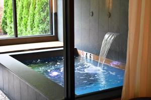 a shower with a fountain in a bathroom with a window at The Swiftwater in Swiftwater