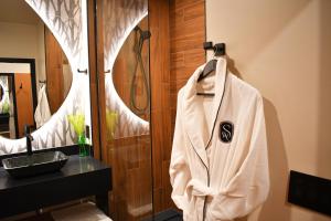a bathroom with a robe hanging on a wall at The Swiftwater in Swiftwater