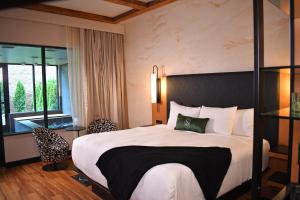 a hotel room with a large bed and a window at The Swiftwater in Swiftwater