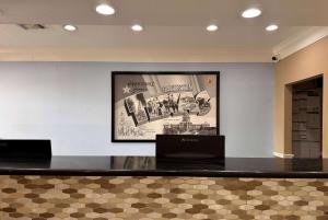 a black counter with a picture on the wall at Super 8 by Wyndham Galveston in Galveston