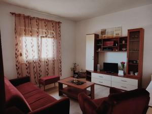 a living room with a couch and a coffee table at Apartman Antonela in Komin