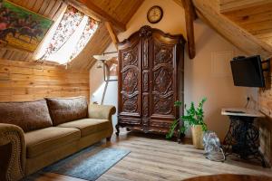 a living room with a couch and a large wooden cabinet at Agroturystyka Hanka i Jurek in Boruja