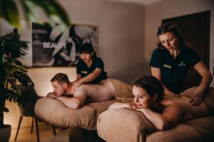 a group of people sitting on beds with their bodies at Elements Hotel&Spa in Świeradów-Zdrój