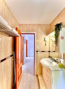 a bathroom with a sink and a mirror at Apartamentos J&K in Torremolinos