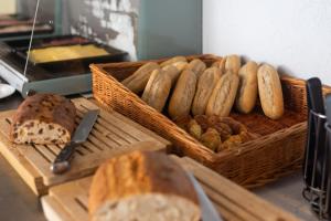 a basket of bread and pastries on a table at Hotel Restaurant Ruimzicht in Zeddam