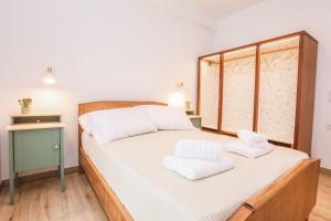 a bedroom with a bed with white towels on it at Casa Biondina, Corfu Town in Corfu Town
