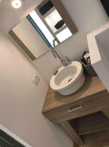 a bathroom with a sink and a mirror at Eco logde & spa in Châteaurenard +10 photos