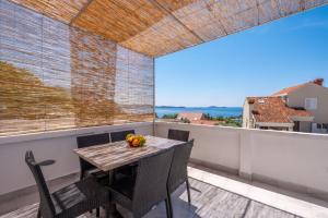 a table and chairs on a balcony with a view at Lucky Bay - Comfort & Terrace Vibes in Mlini