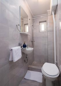 a bathroom with a toilet and a sink and a shower at Lucky Bay - Comfort & Terrace Vibes in Mlini