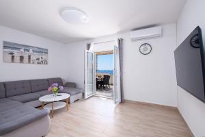 a living room with a couch and a table at Lucky Bay - Comfort & Terrace Vibes in Mlini