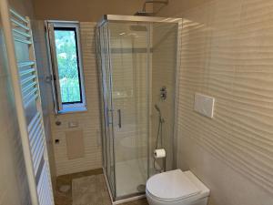 a bathroom with a toilet and a glass shower at Dolce Risveglio in Agerola